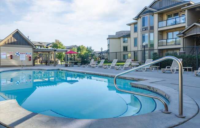 a swimming pool with a building in the background