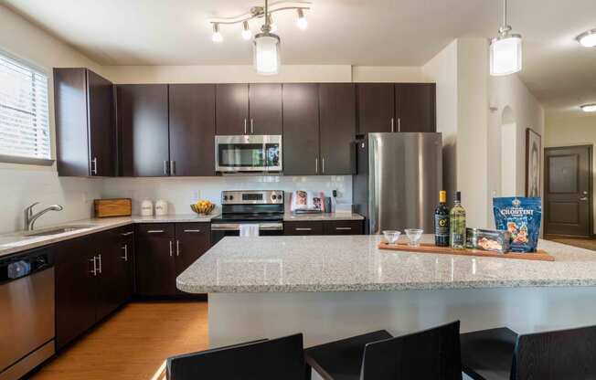 full kitchen with granite counter tops and stainless steel appliances