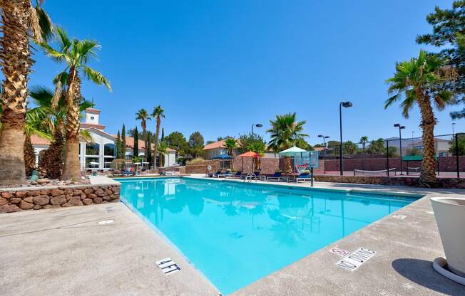 the swimming pool at the resort with palm trees