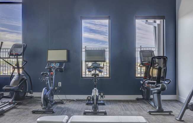 a gym with three treadmills and exercise bikes at Copper 87, West Jordan, UT