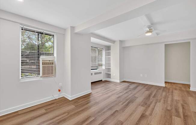 A room with wooden flooring and a ceiling fan.