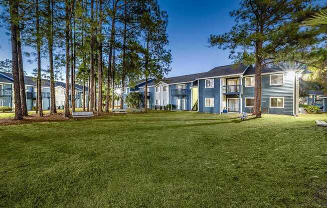 A grassy area in front of apartment buildings.