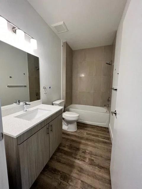 a bathroom with a toilet and a sink and a mirror