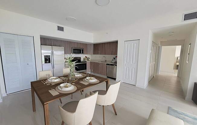 a dining room and kitchen with a table and chairs