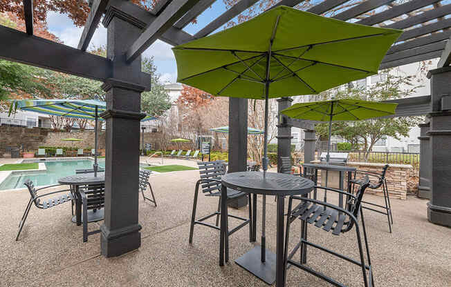 Outdoor BBQ Area with Furniture and Canopy at Bridges at Oakbend Apartments in Lewisville, TX.