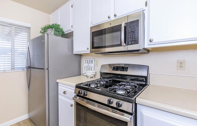 a stove top oven sitting inside of a kitchen