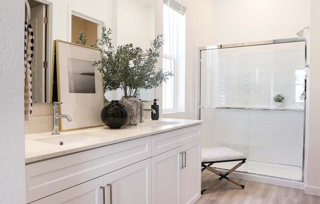 A bathroom with a white cabinet and a white sink.