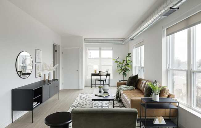 a living room with white walls and a brown leather couch