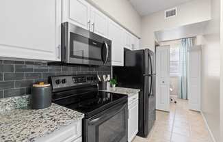 Kitchen with Stainless Steel Appliances at Verona at Boynton Beach Apartments in Boynton Beach, FL 33426