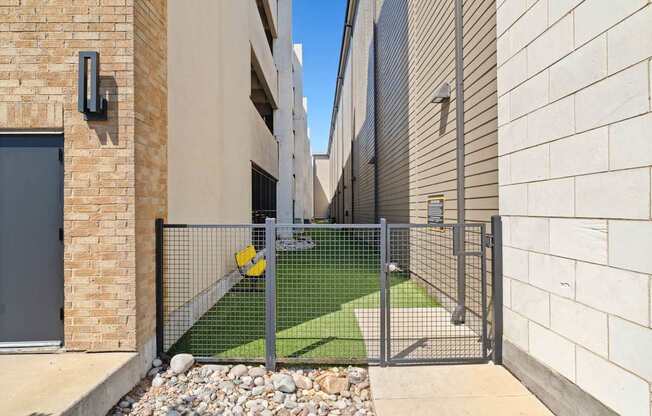 A modern house with a metal gate and a small garden.