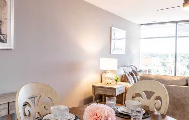 a dining room table set with plates and glasses