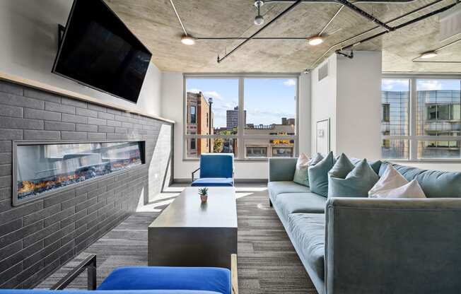 a living room with a fireplace and a large window at Lakeview 3200 Apartments, Chicago, Illinois