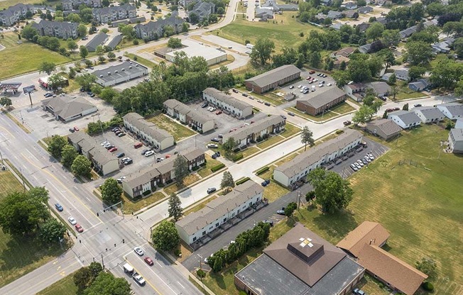 an aerial view of a city with several buildings and a parking lot