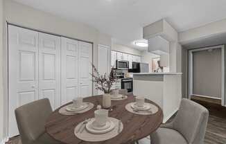a dining room and kitchen with a table and chairs
