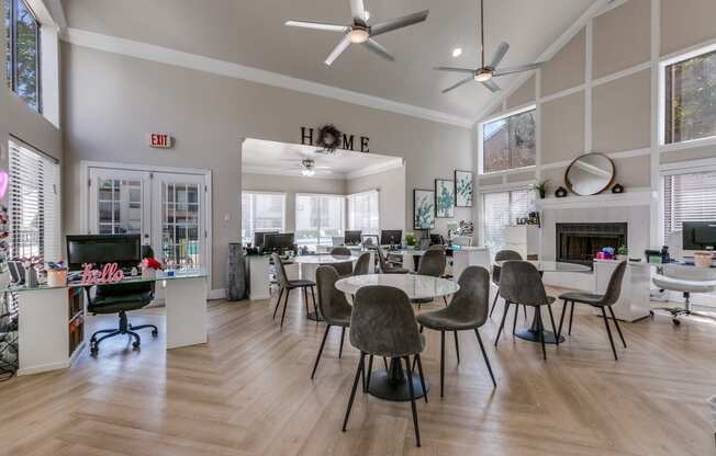 a living room with a table and chairs and a fireplace