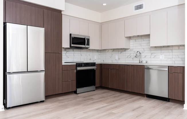 A kitchen with white appliances and brown cabinets.