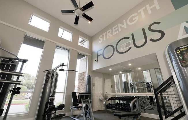 a home gym with a sign that says strength focus