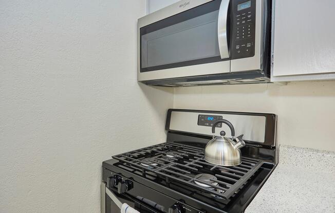 a stove top oven sitting inside of a kitchen