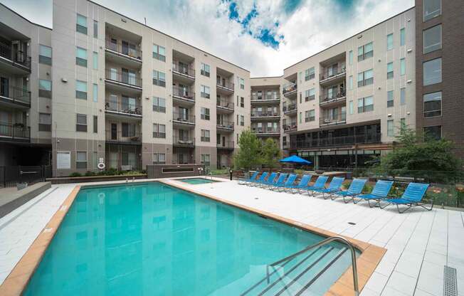 A large swimming pool in front of apartment buildings at Regatta Sloans Lake Apartments, Denver 80204