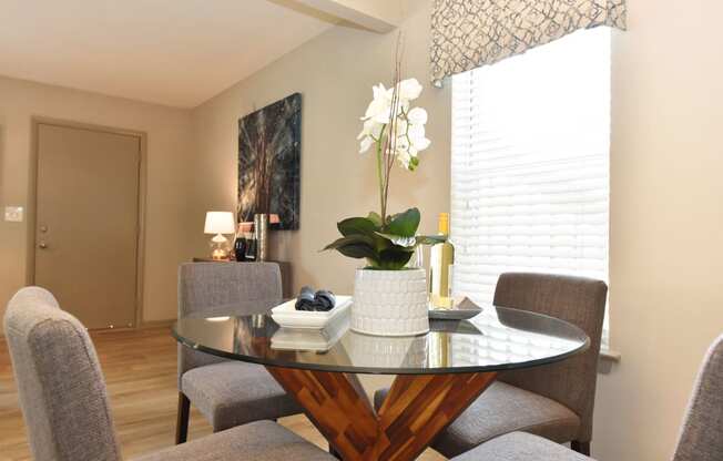 a dining room with a table and chairs