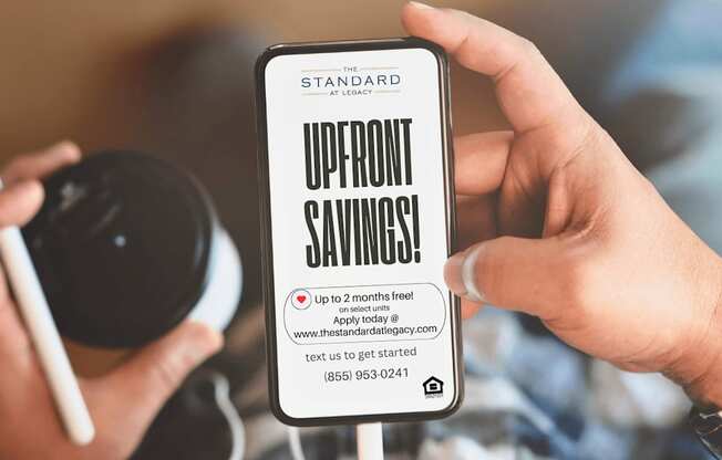 A person holding a smartphone displaying an offer for up to 2 months free.