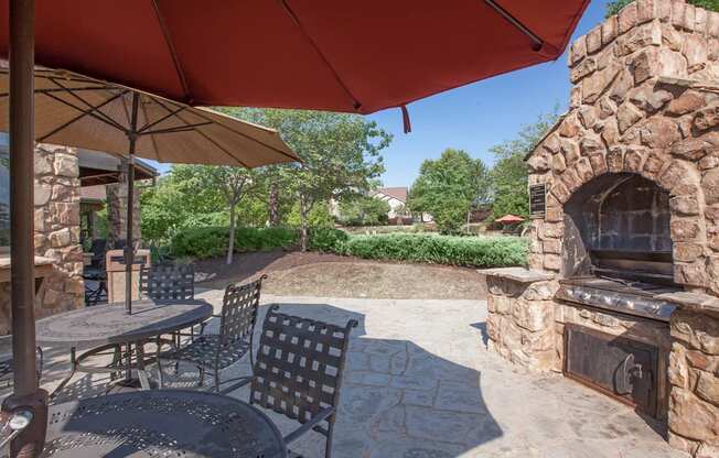 Shaded seating at the pool grill station at Stonepost Ranch Apartments in Overland Park, KS.