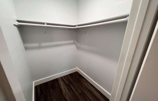 the preserve at ballantyne commons empty closet with wood floor and white walls