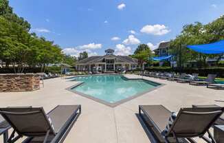 the resort style pool is surrounded by lounge chairs and umbrellas