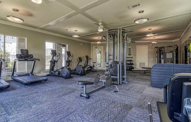 A spacious gym with a variety of equipment including treadmills, weights, and exercise machines.