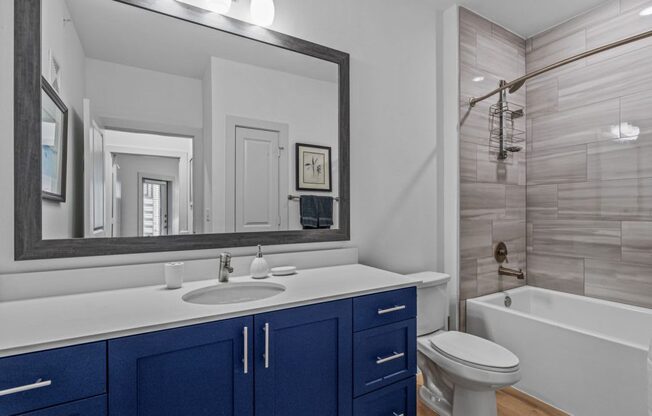 a bathroom with a sink and a toilet and a shower