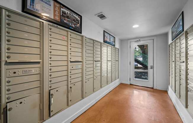 the mail room has plenty of mailboxes and a door to the street