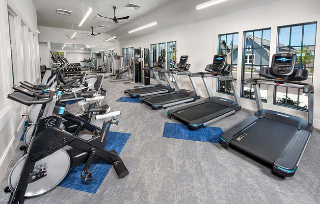 fitness center with bikes and treadmills