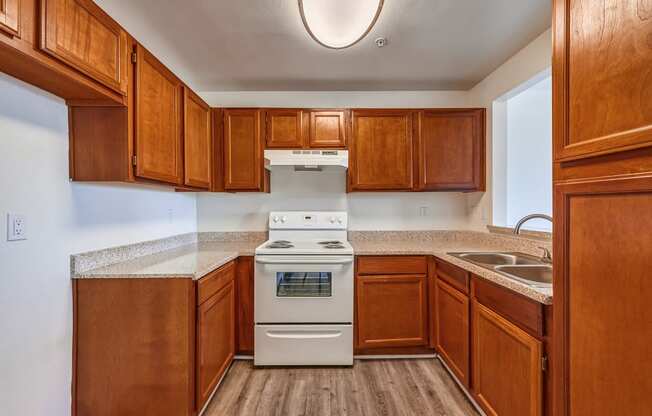 a kitchen with wood cabinets and white appliances