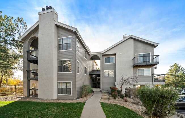 A modern two-story house with a balcony on the second floor.