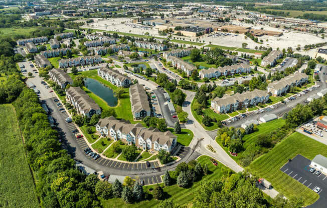 A bird's eye view of a residential area with houses and a roundabout