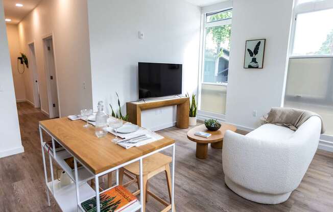 a living room with a table and a couch and a television