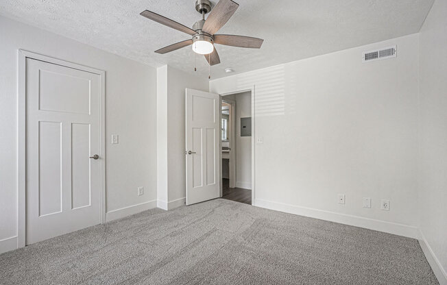 bedroom with a ceiling fan and walk in closet at The Crossings Apartments, Michigan, 49508