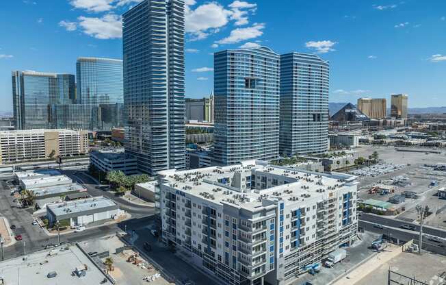 A cityscape with a mix of modern and older buildings under a clear blue sky.