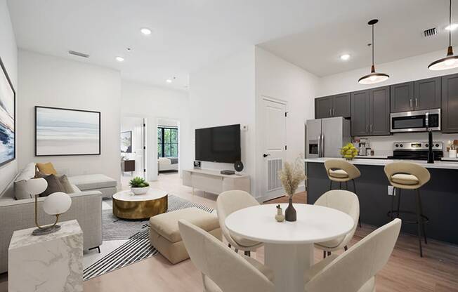 an open living room and kitchen with a table and chairs