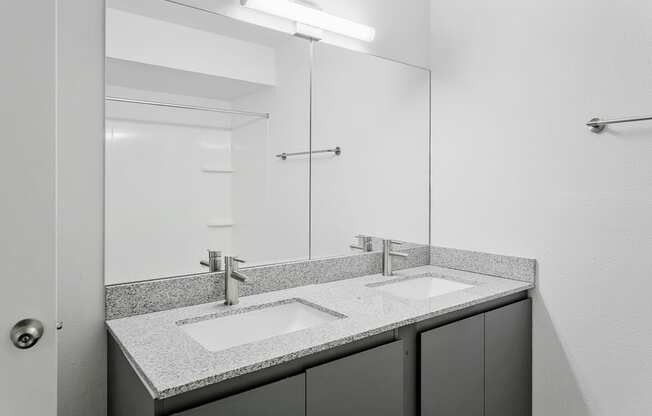 A bathroom with a sink and mirror.