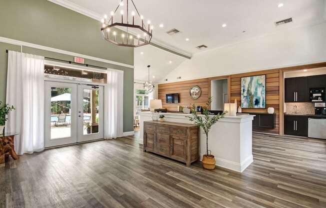 A modern kitchen with a wooden floor and a white counter.