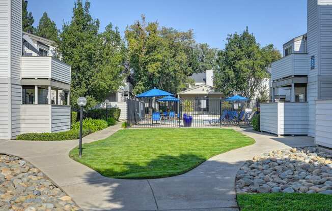 Cobblestone Creek Apartments  exterior grounds with green grass and lighted  walk paths.