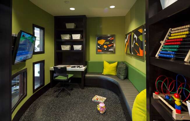 a childs play room with a desk and a chair