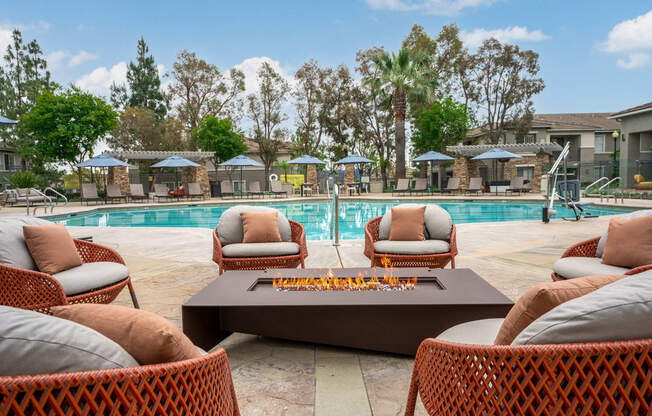 a swimming pool with chairs and a coffee table