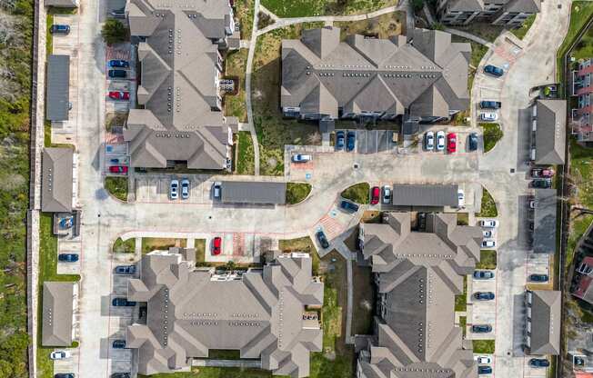 A bird's eye view of a residential area with houses and cars.