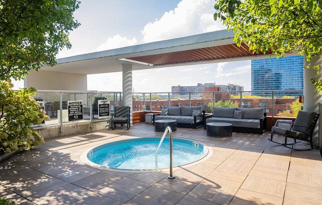 A pool with a hot tub in the middle of a patio.