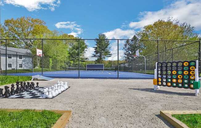 A playground with a chess set on the ground.