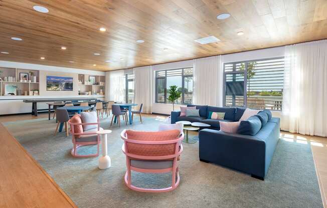 A modern living room with a wooden ceiling and a large window.