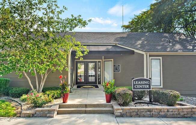 a home with a leasing center sign in front of it