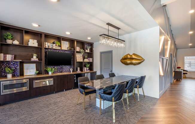 a dining room with a table and chairs and a tvat Paisley and Pointe Apartments, Las Vegas